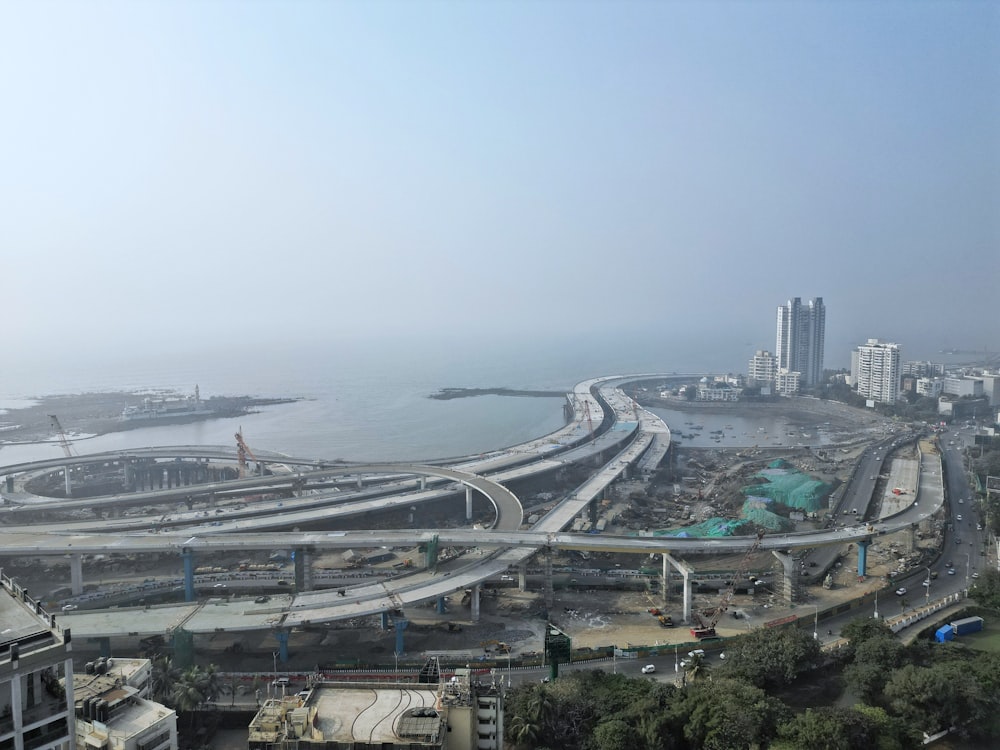 an aerial view of a highway and a large body of water