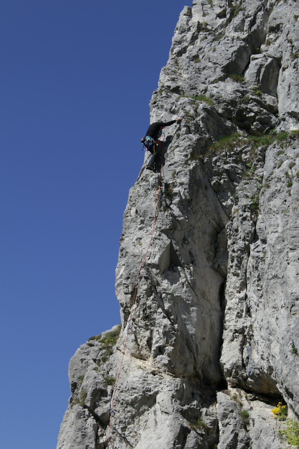 a man climbing up the side of a mountain