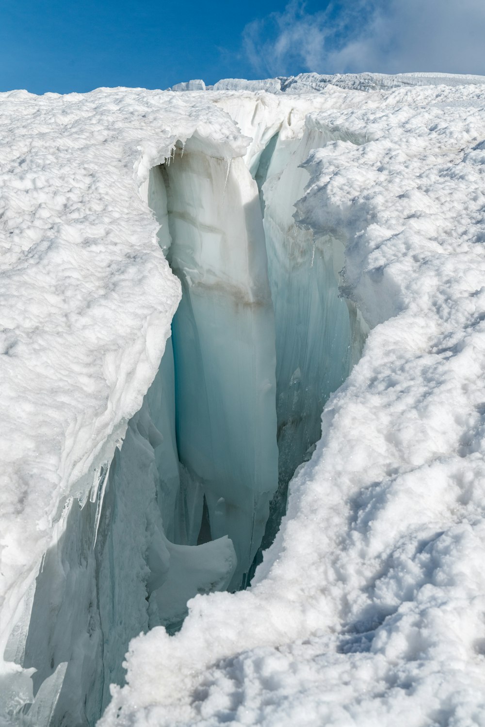 a crack in the ice with a sky background