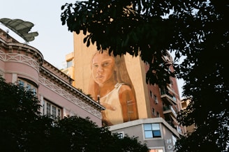 a large mural of a woman on the side of a building