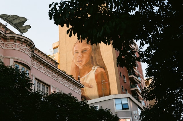a large mural of a woman on the side of a building