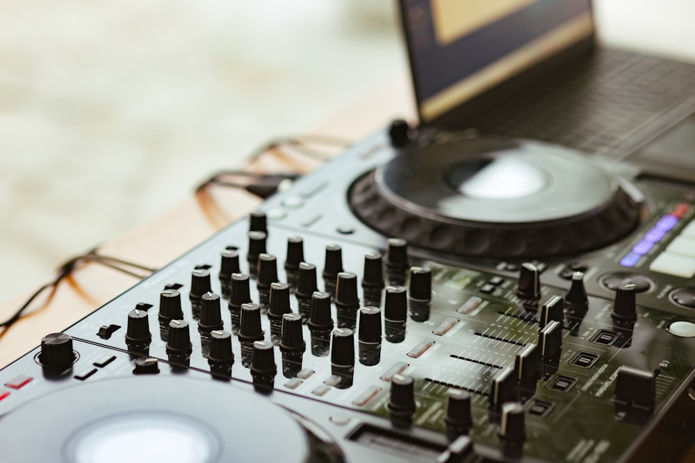 a dj's turntable with a laptop in the background