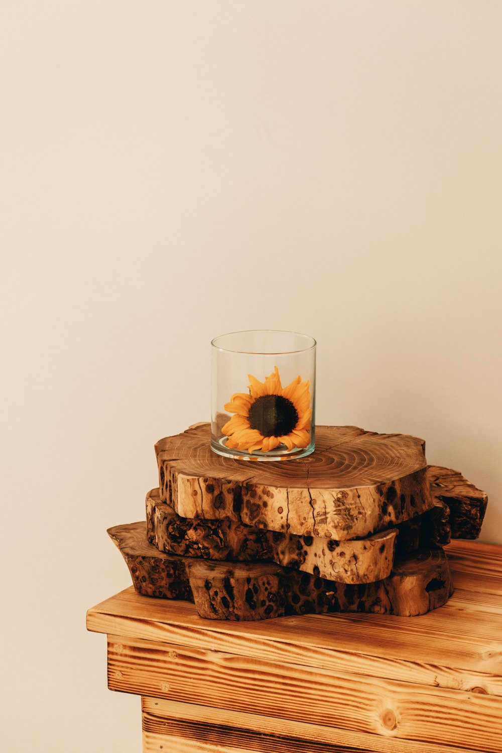 a glass of water sitting on top of a wooden table