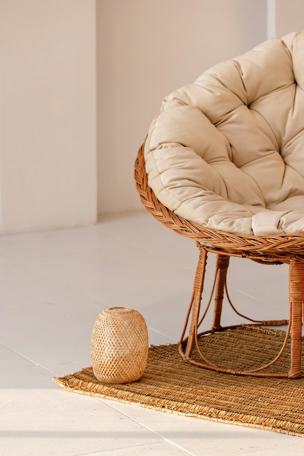 a wicker chair and ottoman on a rug