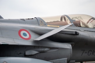 a fighter jet sitting on top of an airport tarmac