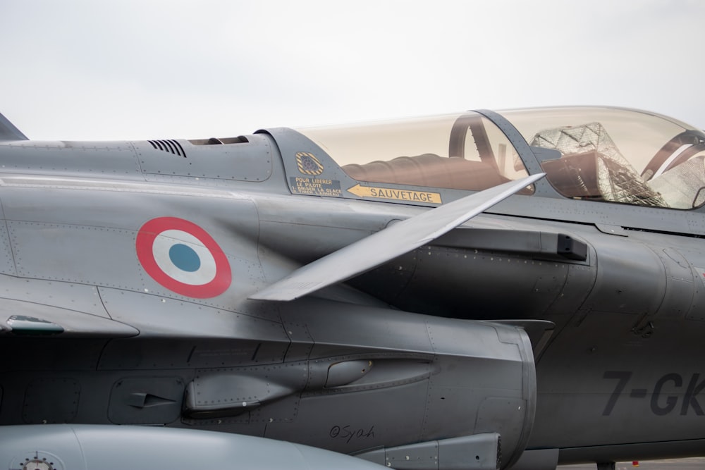 a fighter jet sitting on top of an airport tarmac