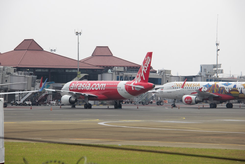 a couple of airplanes that are on a runway