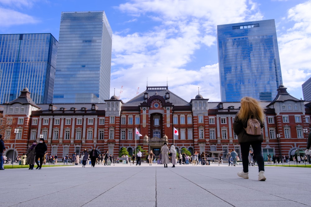 a group of people walking in front of a building