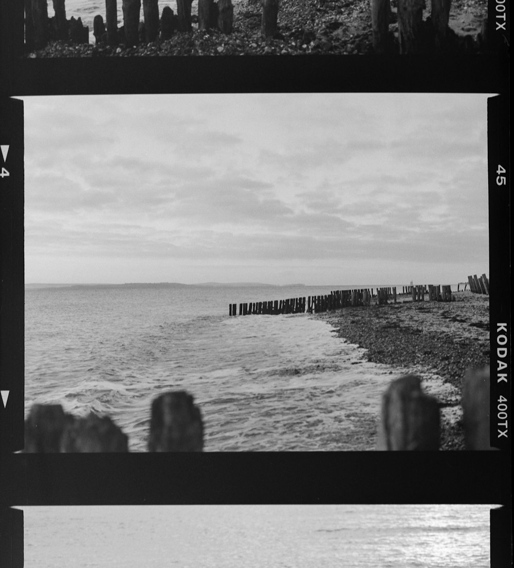 a black and white photo of a beach and ocean