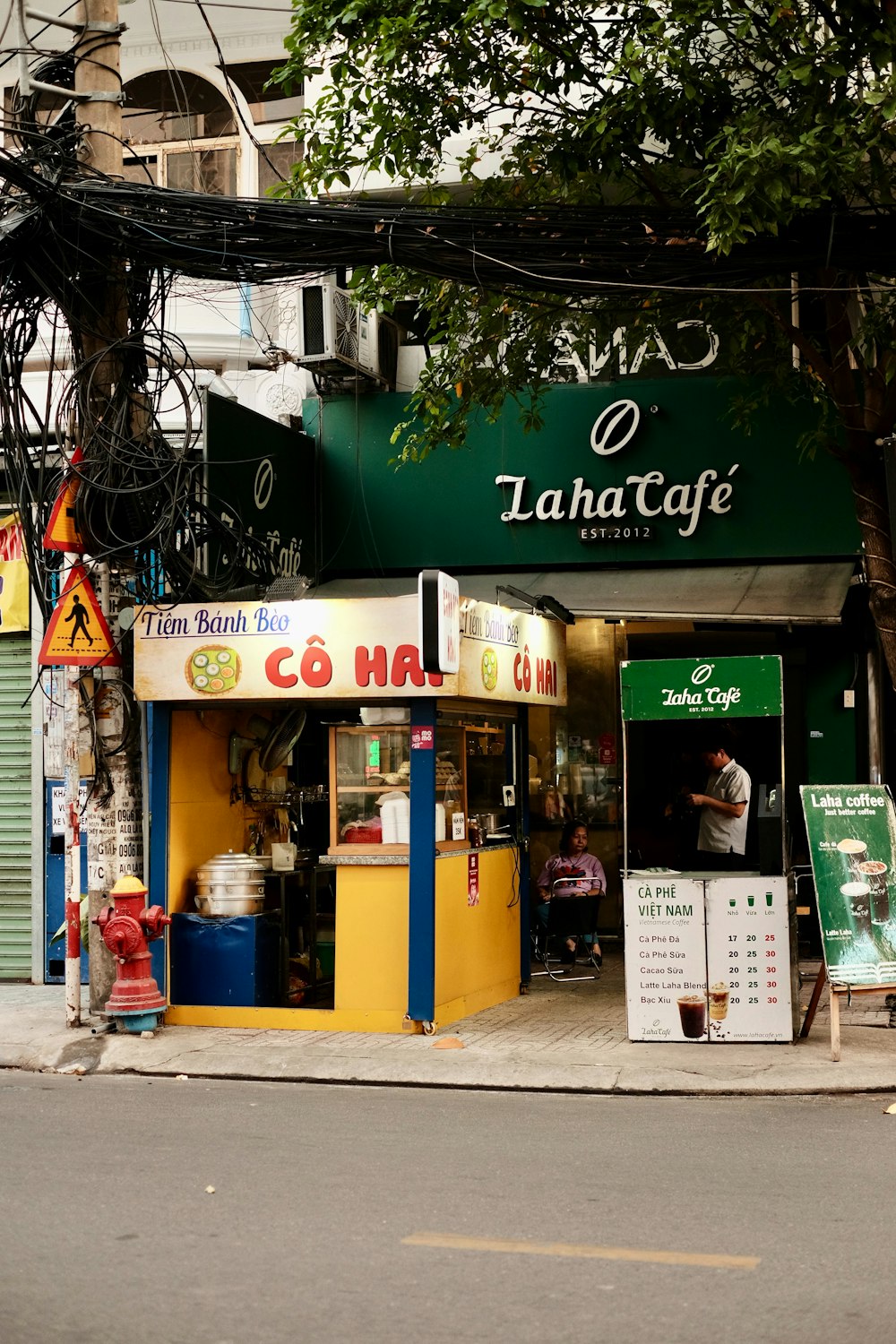 a street corner with a coffee shop and a fire hydrant