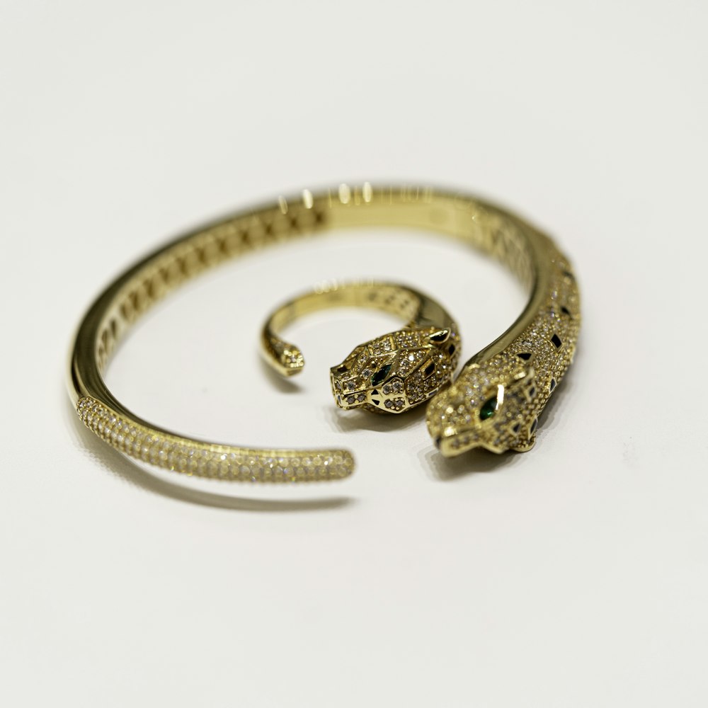 a snake bracelet with a snake head on top of it