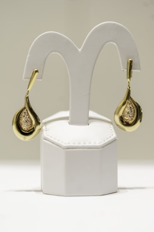a pair of gold and diamond earrings
