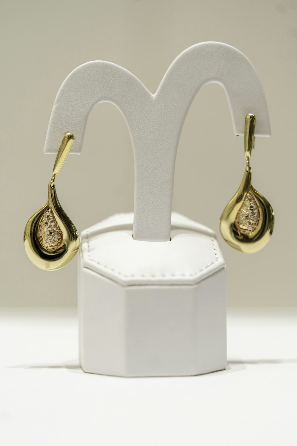 a pair of gold and diamond earrings