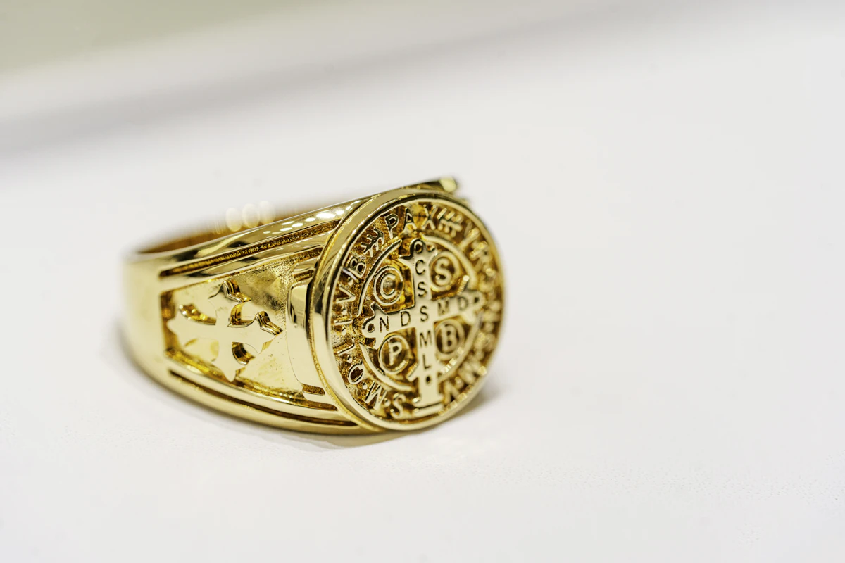 Close up of a gold ring on a white surface