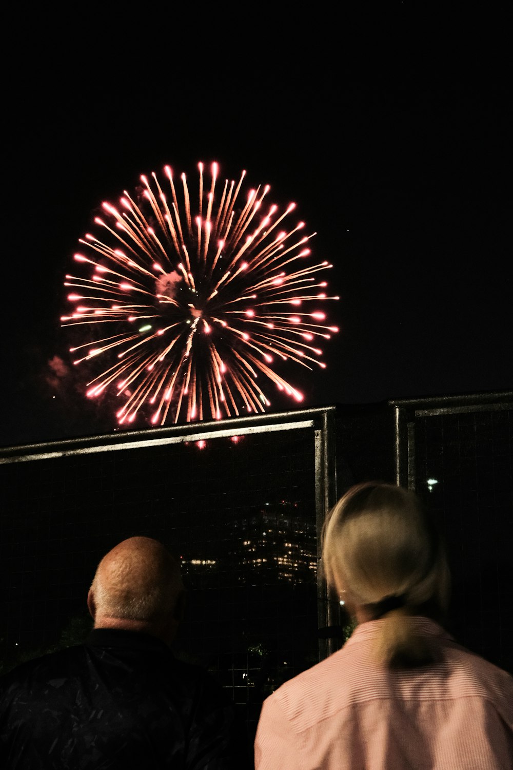a man and a woman looking at a fireworks display