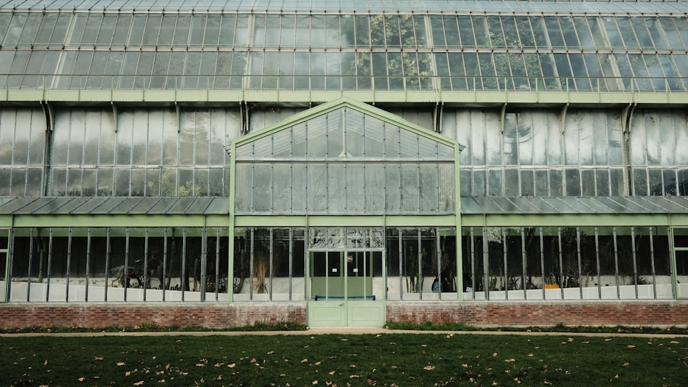 a large building with a green door and glass windows