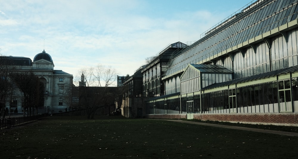 a large building with many windows and a clock tower in the background