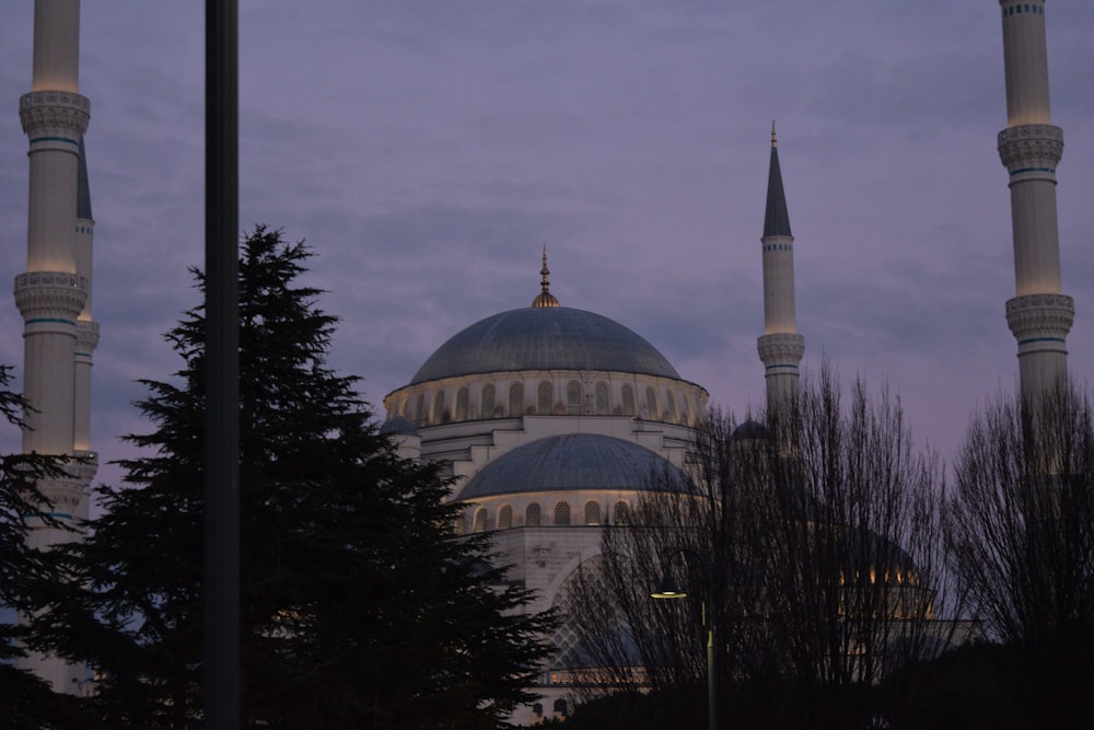 a large white building with a dome and two spires