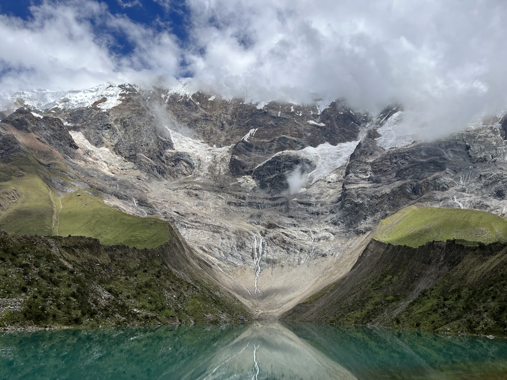 a mountain range with a lake in the foreground