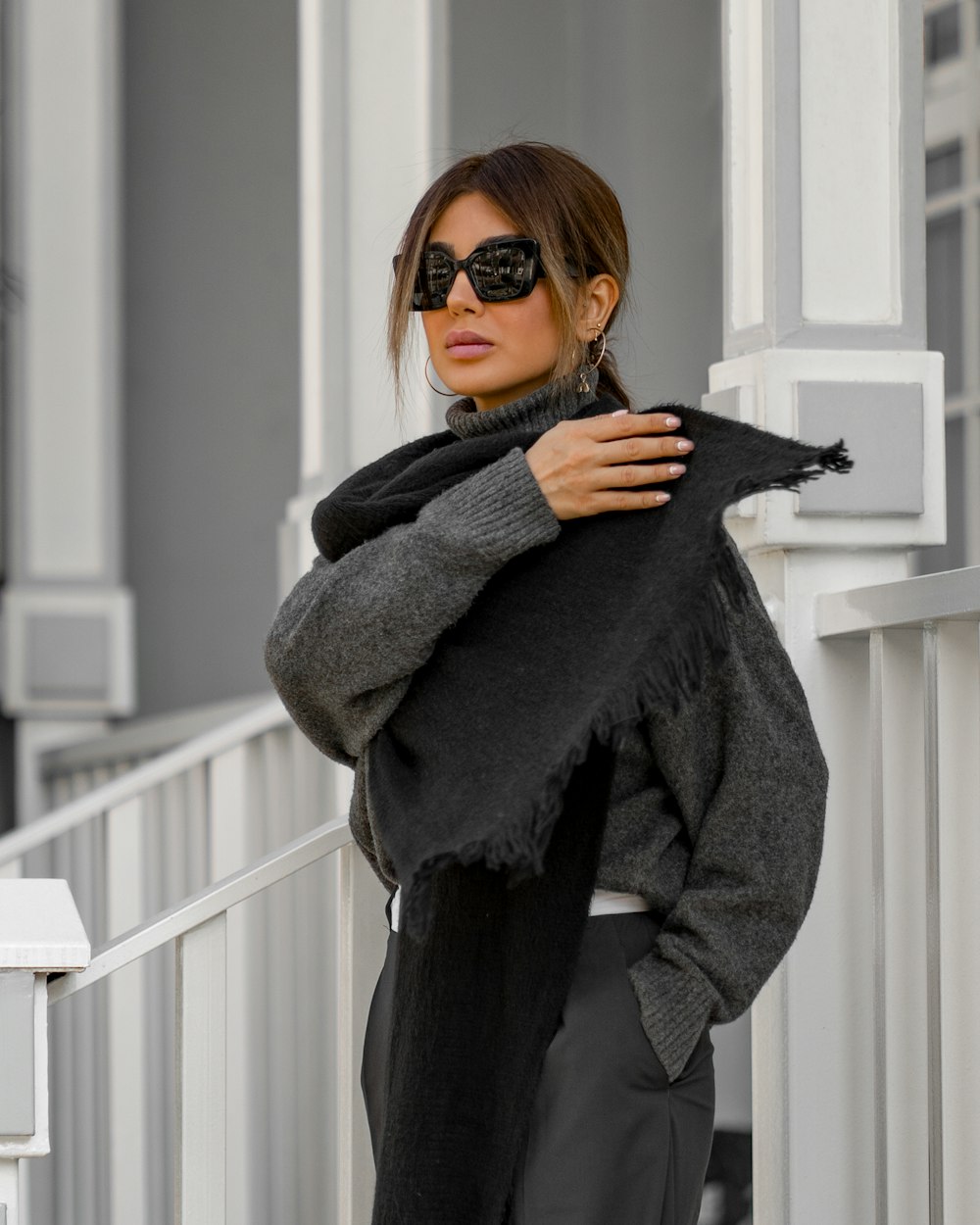a woman wearing sunglasses and a black scarf