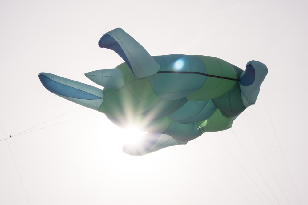 a large kite shaped like a fish flying in the sky