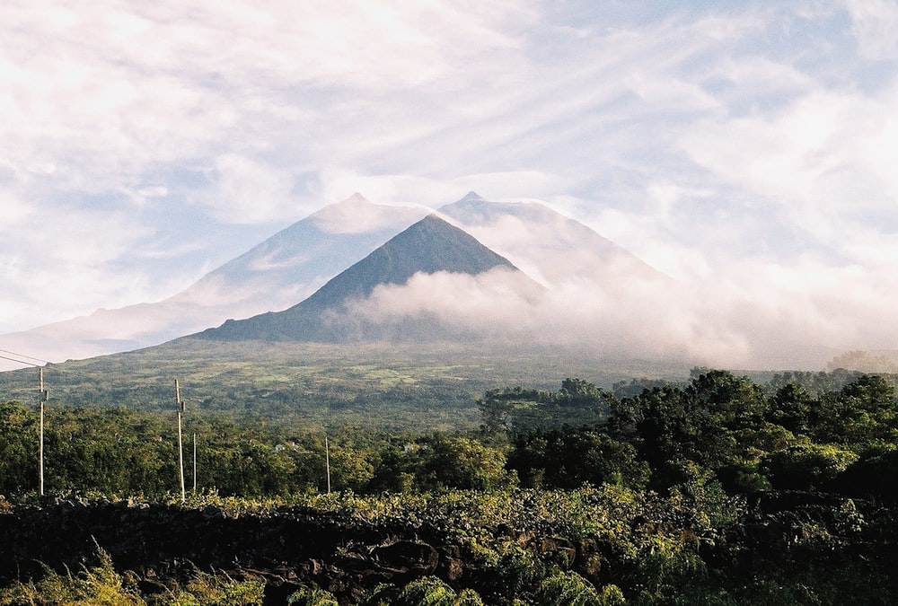 a view of a mountain with clouds in the sky