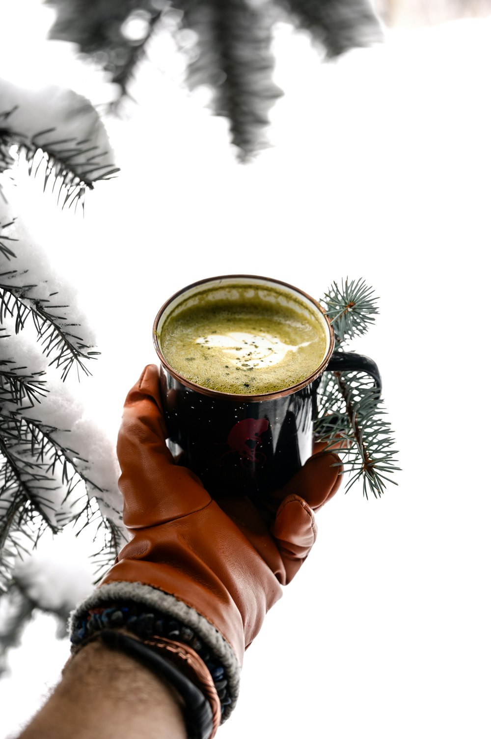 a person holding a cup of coffee in their hand