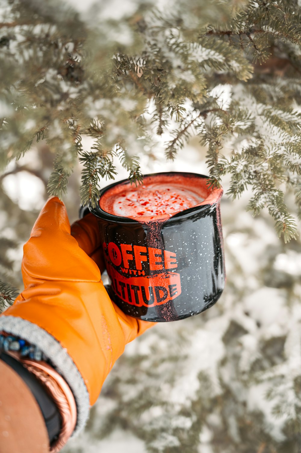 a person holding a cup of coffee in their hand