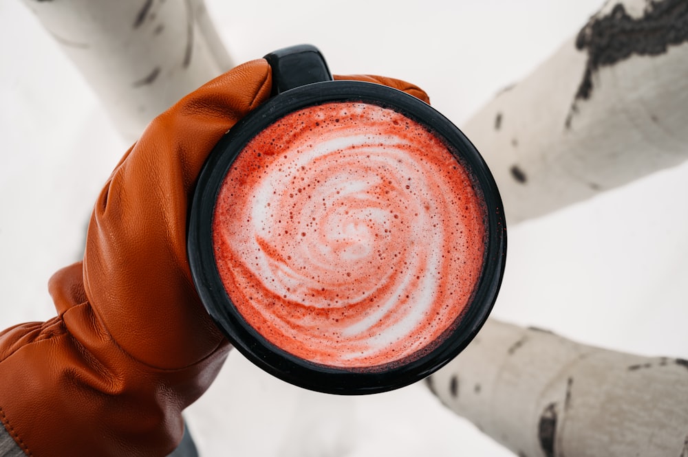 a person holding a cup of hot chocolate