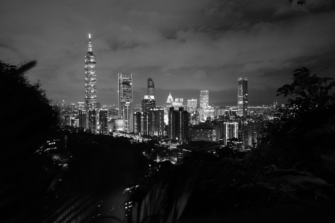 a black and white photo of a city at night,