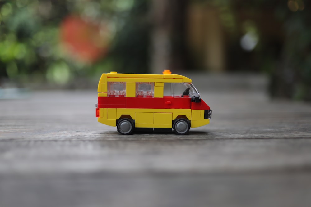 a toy bus is sitting on the ground