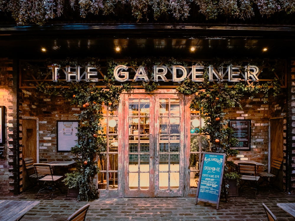 the entrance to a restaurant with a sign in front of it