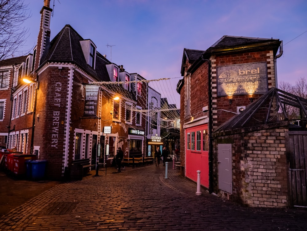 a cobblestone street lined with brick buildings