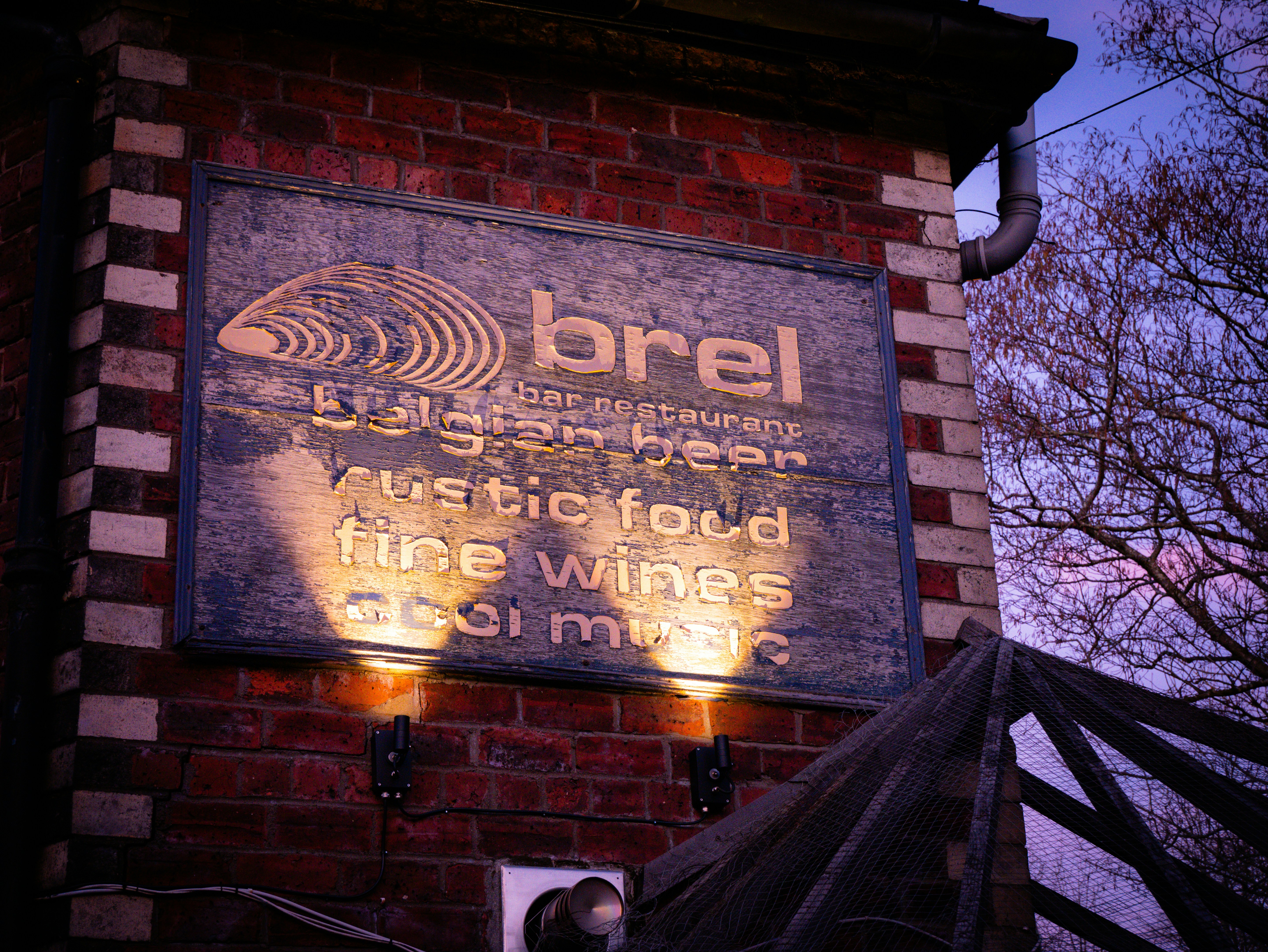 A sign on the side of a brick building