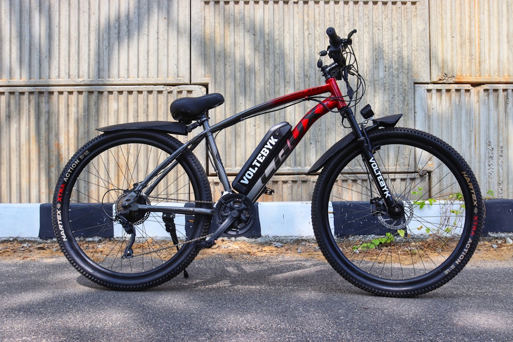 a black and red bike parked in front of a building