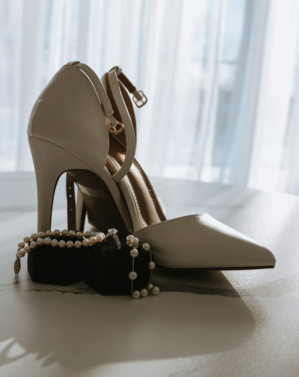 a pair of high heeled shoes sitting on top of a table