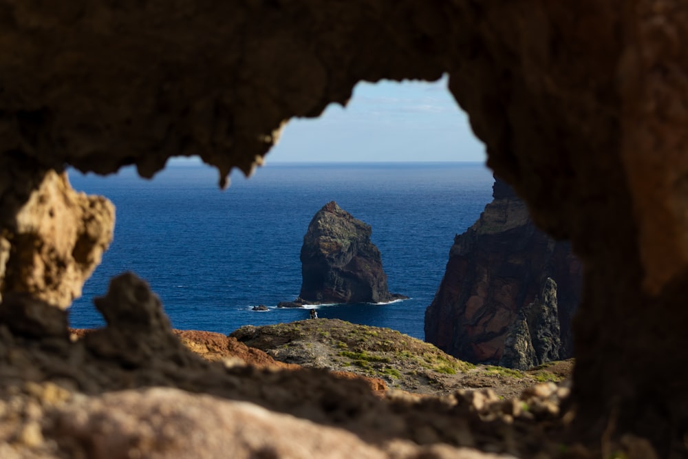 a view of a body of water through a cave