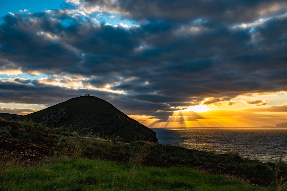 the sun is shining through the clouds over the ocean