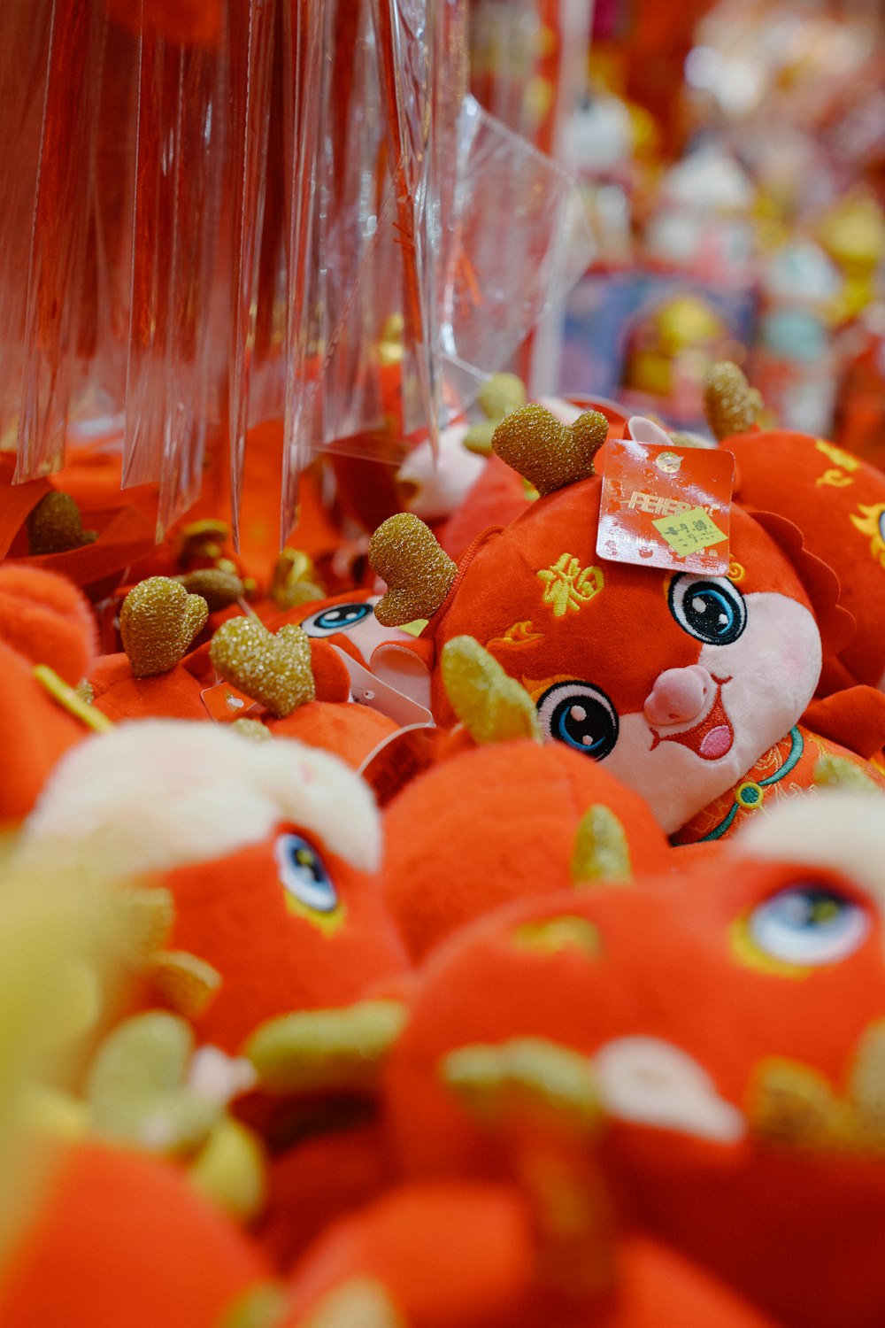 a group of red stuffed animals sitting on top of a table