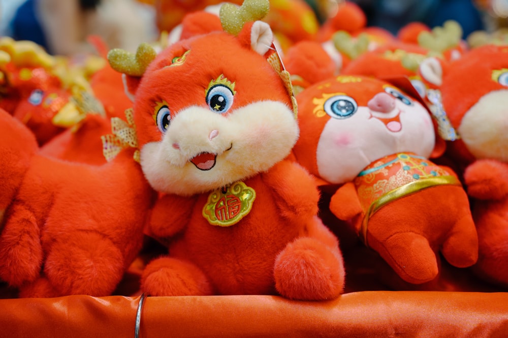 a group of red stuffed animals sitting next to each other