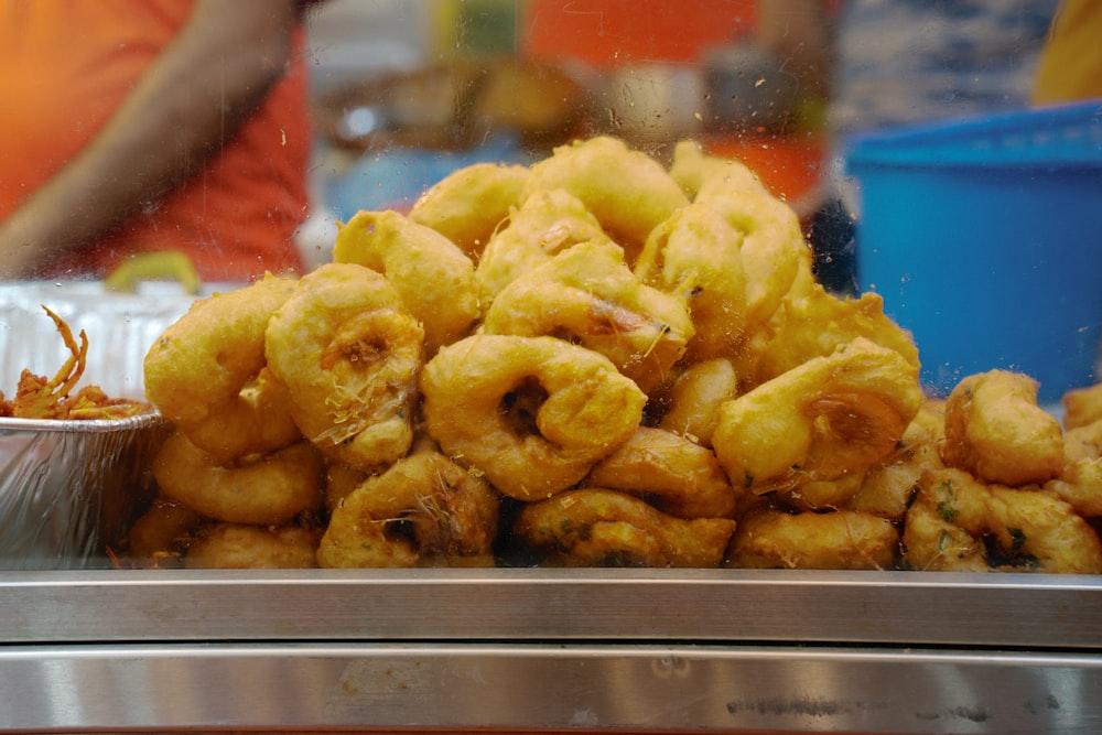 a pile of fried food sitting on top of a metal tray