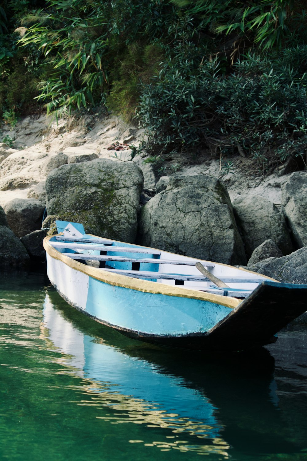 a small boat sitting on top of a body of water