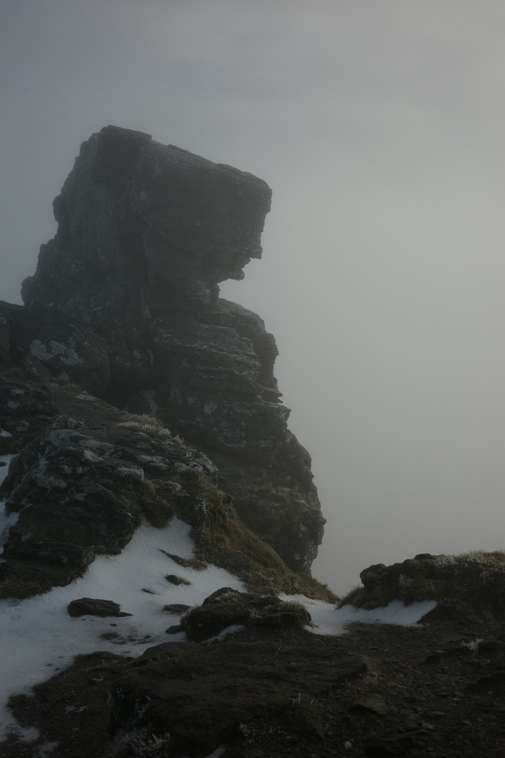 a person standing on top of a snow covered mountain