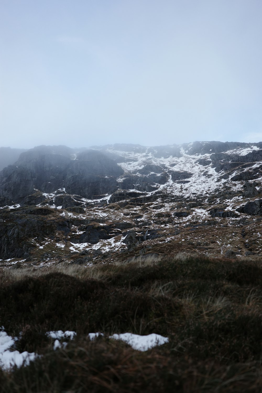 a mountain covered in snow on a cloudy day