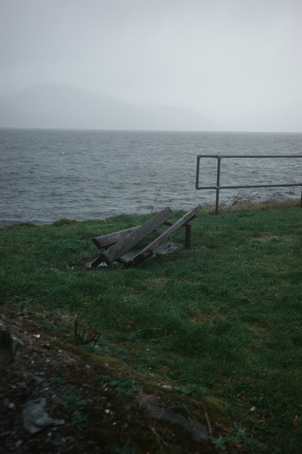 a bench sitting on top of a lush green field