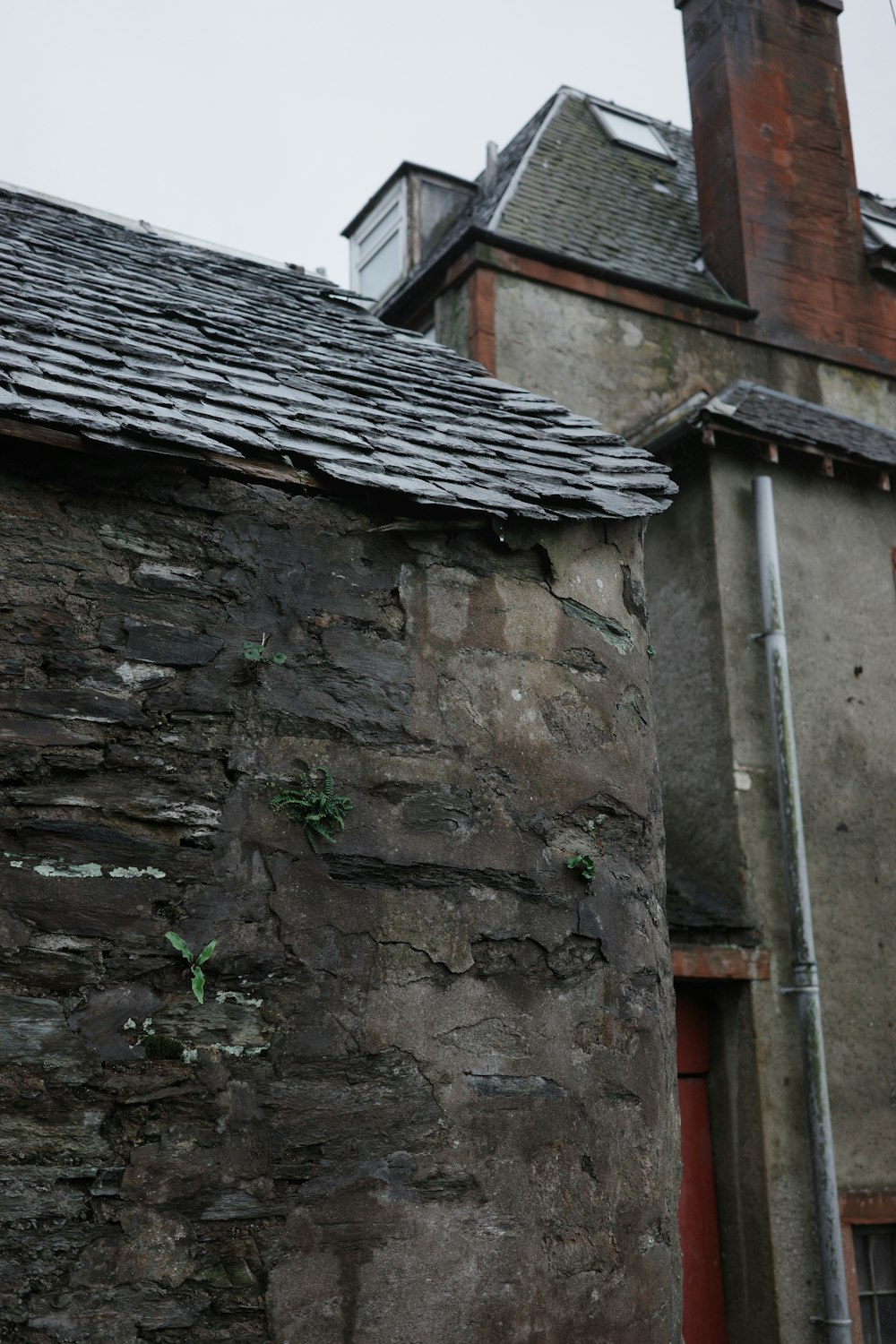 a stone building with a clock tower next to it