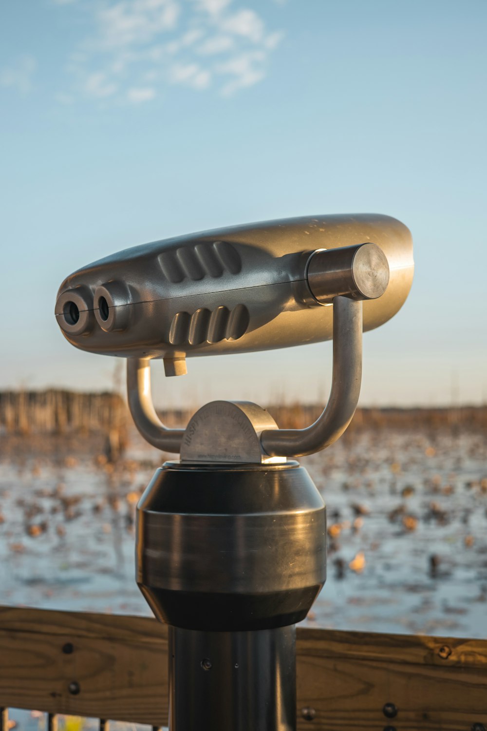 a close up of a metal object near a body of water