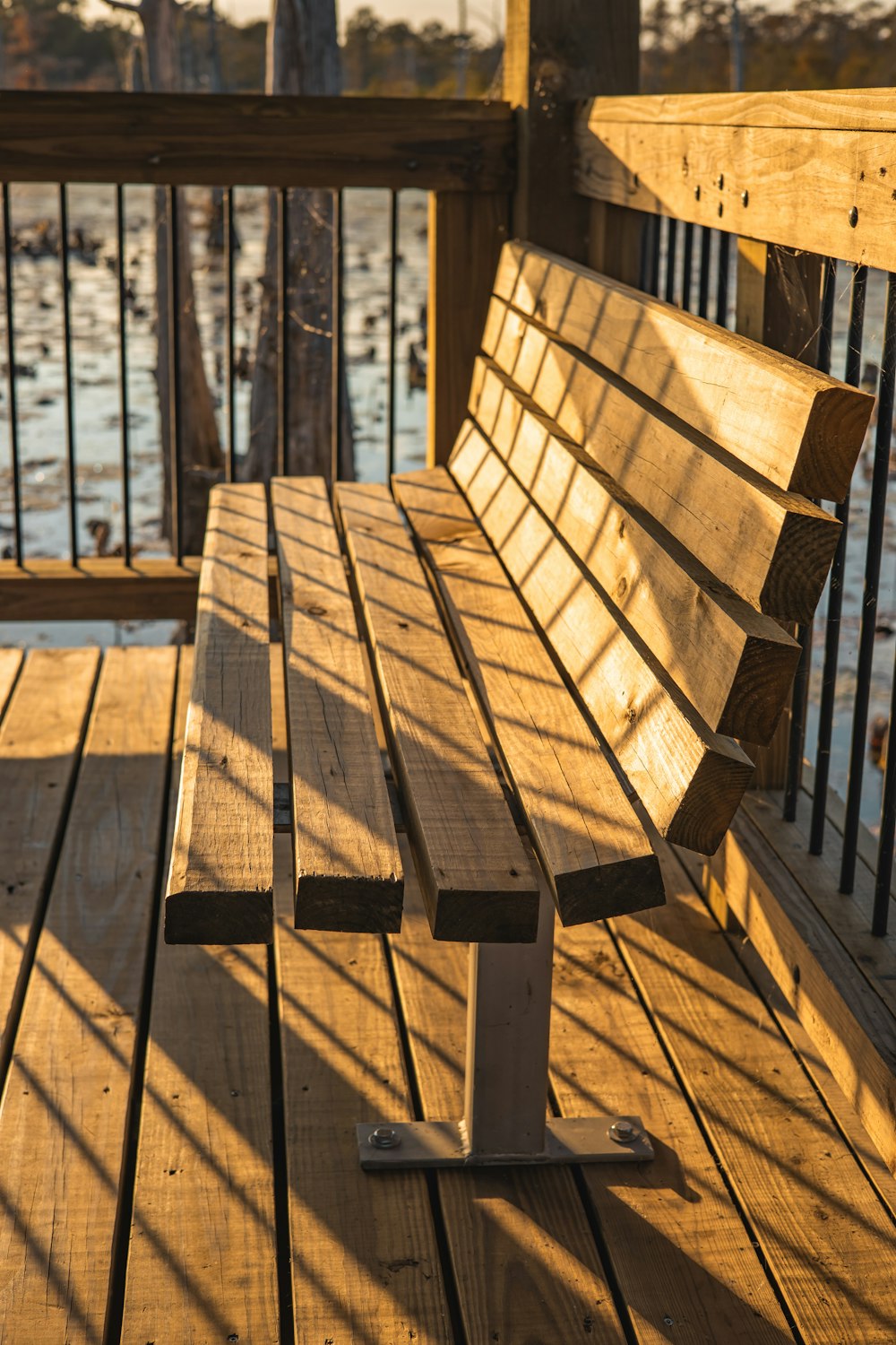 a wooden bench sitting on top of a wooden deck