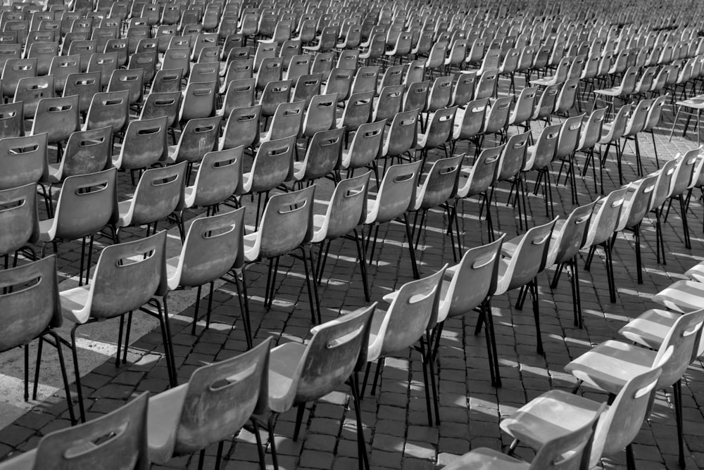 a row of empty chairs sitting in a parking lot