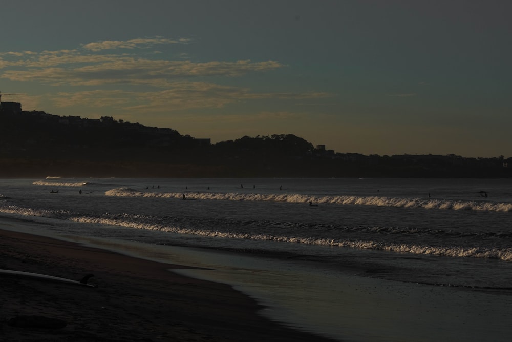 a view of a beach with a hill in the background